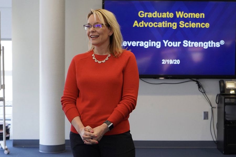 Julie Lockman making a presentation. Text on presentation slide: Graduate Women Advocating Science.